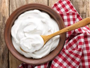 bowl of yogurt with wooden spoon